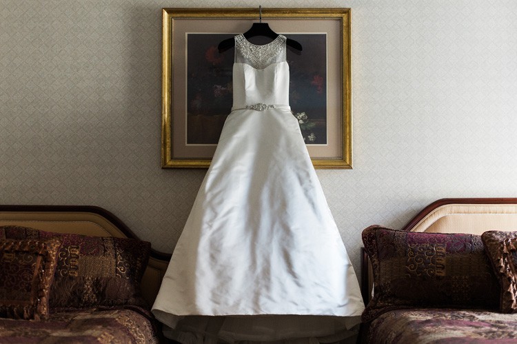 Omni William Penn Wedding White Gown with Neck Beading Hanging Up