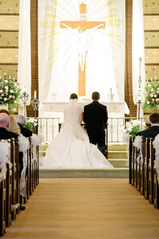 Circuit Center Ballroom Wedding Ceremony - Couple Kneels During Ceremony
