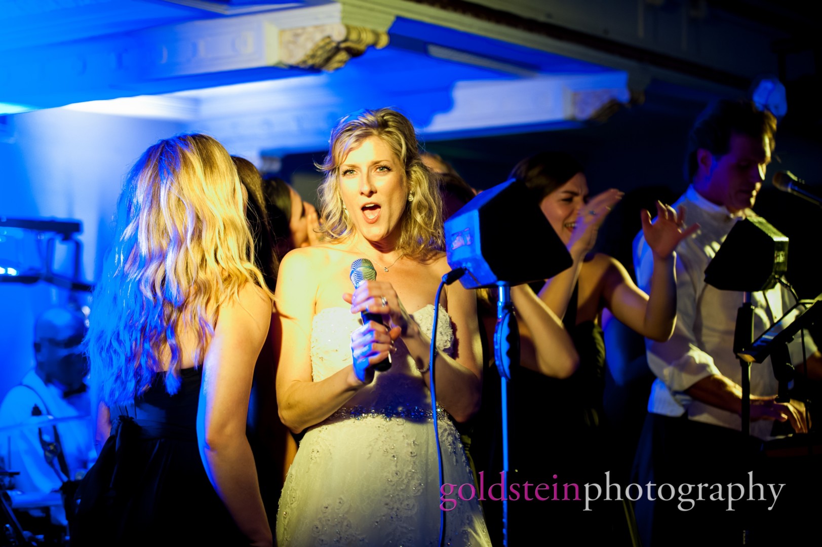 a bride sings with the John Parker Band at her wedding